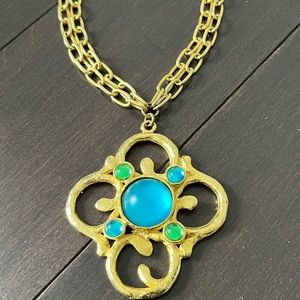 Statement Gold Tone necklace with medallion & teal and gold stone accents.